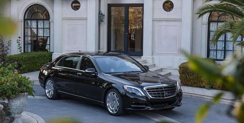 Chauffeur driven sedan parked outside Cannes luxury hotel